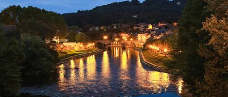 A river with a bridge and buildings in the background.