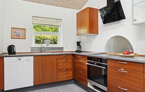 Fridge, stovetop, dishwasher, coffee/tea maker