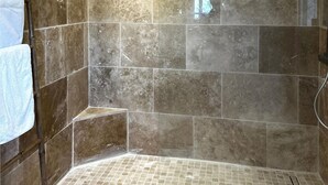 A shower area with tiled walls and floor, a towel rack, and a showerhead. - Nice home in Sainte Maxime with WiFi (Sainte Maxime)