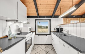 Fridge, stovetop, dishwasher, coffee/tea maker