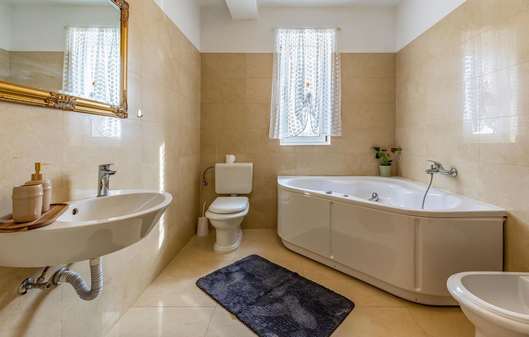 A bathroom with a freestanding bathtub, a sink, and a toilet.
