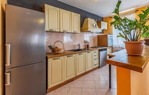 Fridge, stovetop, dishwasher, coffee/tea maker