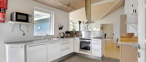 Fridge, stovetop, dishwasher, coffee/tea maker