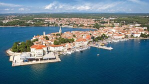 An aerial view of a coastal town with a marina, historic buildings, and a prominent church tower. - Holiday apartment with garden terrace near the beach Špadići Poreč (Poreč)