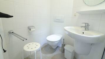 Shower, hair dryer, towels, toilet paper