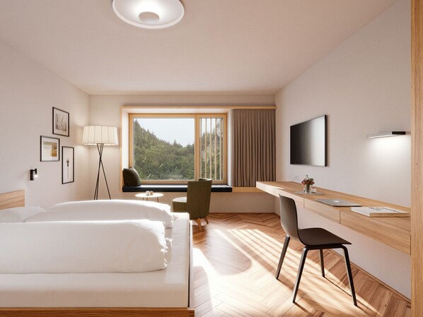 A hotel room with a bed, desk, chair, TV, window, and lamp.