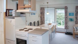 A compact kitchen with a central island, a microwave, and a stove. - 2 bedroom nice home in Hejls (Hejls)