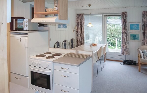 Enjoy meals in this well-equipped kitchen with a central island, oven, and microwave, plus a dining area for family meals.
