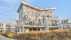 A modern multi-story building with balconies, large windows, and a flat roof. - 3 bedroom gorgeous apartment in Travemünde Waterfront (Travemünde Waterfront)