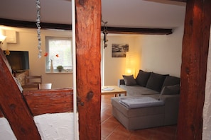 Ein Wohnzimmer mit einer Couch, einem Couchtisch und einem Fernseher.