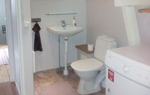 A small bathroom with a white sink, toilet, and a white washing machine. - 2 bedroom cozy home in Kosta (Kosta)
