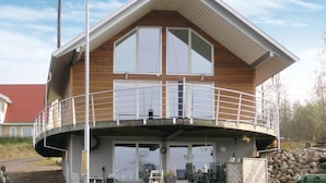 A two-story house with a balcony, large windows, and a garage. - 1 bedroom amazing home in Månsarp (Månsarp)