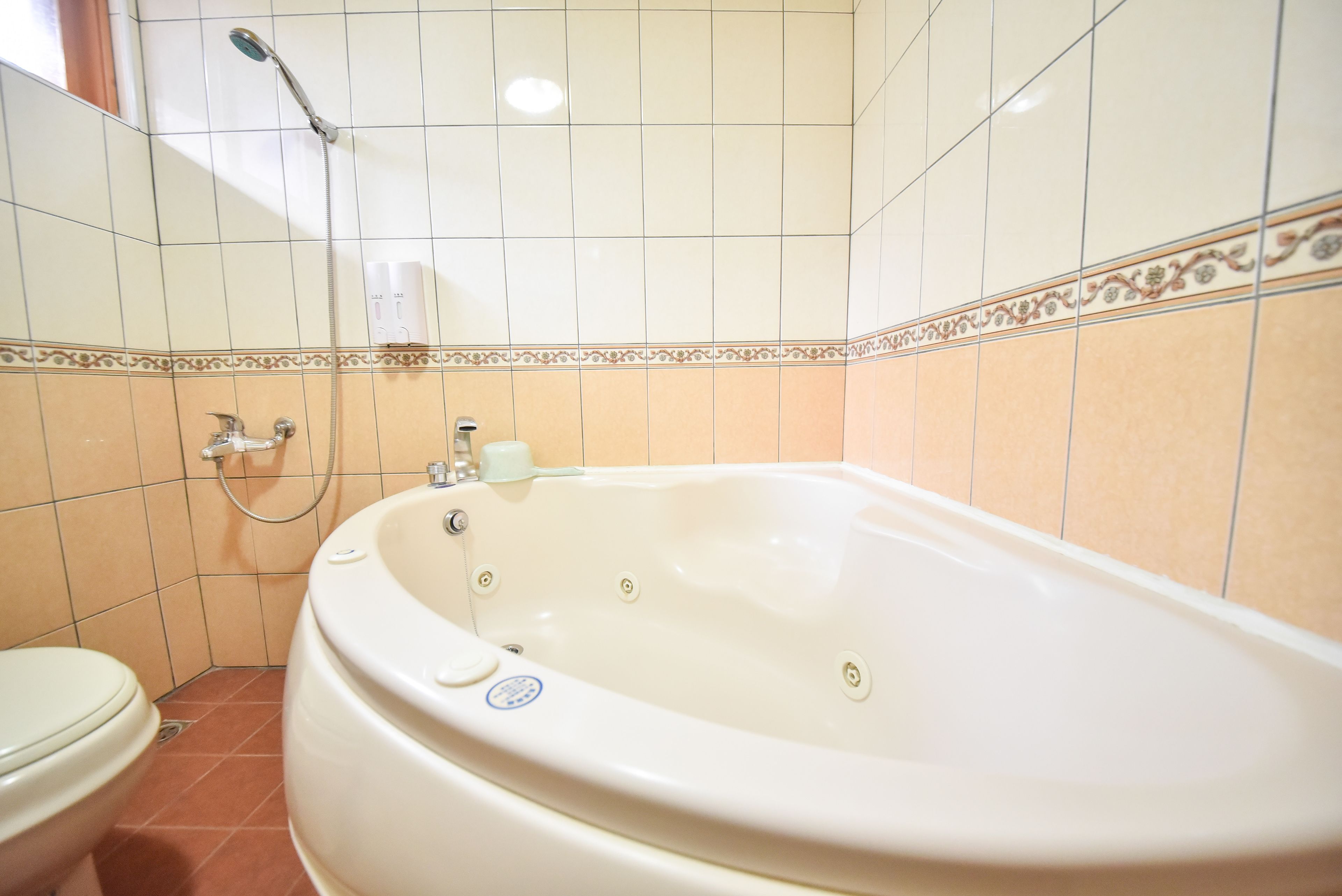 A bathroom with a bathtub, toilet, and shower.