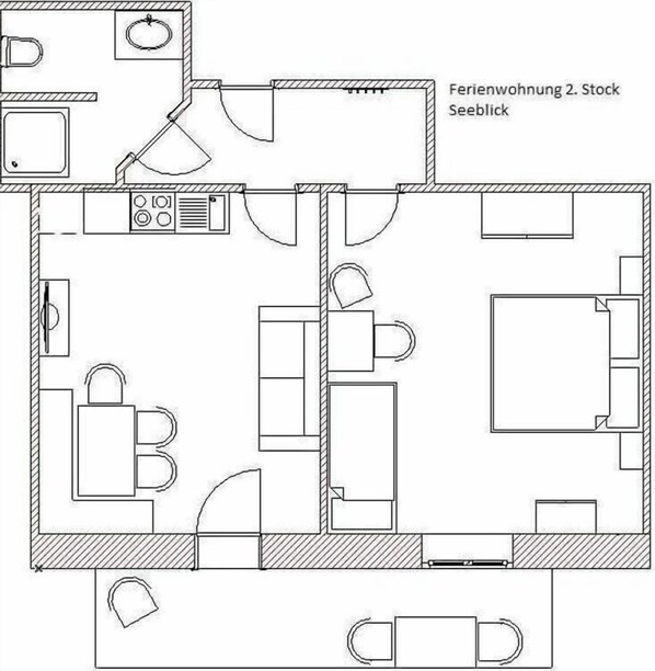 Plan d’étage d’une chambre d’hôtel comprenant un coin cuisine, une salle de bain et un espace salon.