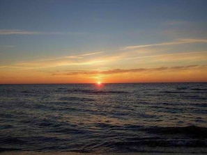 A sunset over the ocean with a clear horizon.