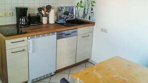 Keittiössä on mikroaaltouuni, leivänpaahdin, pesuallas ja erilaisia keittiövälineitä.