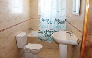 A bathroom with a toilet, bathtub, and sink. - Stunning home in Torrox (Torrox)