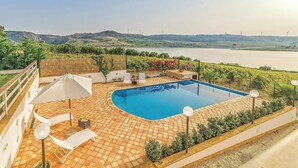 A swimming pool with a view of a river and wind turbines in the distance. - Beautiful home in Sambuca di Sicilia AG (Sambuca di Sicilia AG)