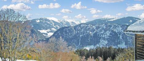Eine Berglandschaft mit schneebedeckten Gipfeln und blauem Himmel.