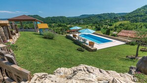 A backyard with a swimming pool, a wooden deck, and a gazebo. - Beautiful home in Gologoricki Dol (Gologoricki Dol)