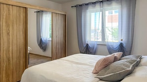 A bedroom with a bed, pillows, and a wardrobe. - Beautiful home in Vrsi (Vrsi)