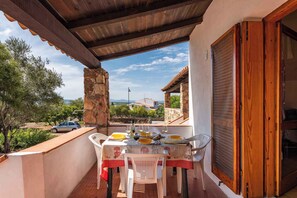 Ein Balkon mit Tisch für zwei Personen, mit Blick auf eine malerische Landschaft.