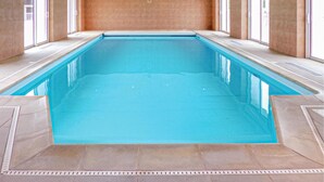 An indoor swimming pool with clear glass walls, a tiled floor, and a tiled ceiling. - Nice home in Vaudoy-en-Brie with WiFi (Vaudoy-en-Brie)