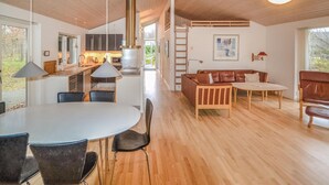 A modern interior with a dining area, kitchen, and seating space. - Lovely home in Grenaa with sauna (Grenaa)