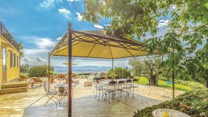 An outdoor patio with a covered seating area, a pool, and a view of the landscape. - Nice home in Castiglione d.Lago PG (Castiglione d.Lago PG)