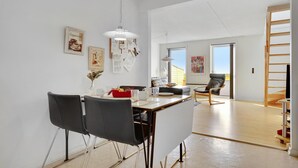 A modern dining area with a table, chairs, and a view of the outdoors. - 3 bedroom lovely apartment in Rømø (Rømø)