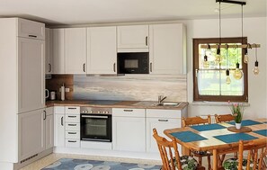 Fridge, stovetop, dishwasher, coffee/tea maker