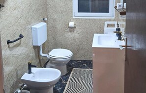 A compact bathroom with a toilet, bidet, and sink. - Nice apartment in Jadrija with house sea view (Jadrija)