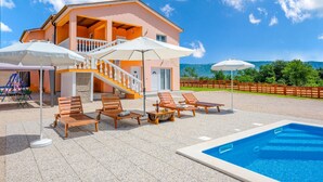 A two-story house with a pool, outdoor seating, and a view of the mountains. - Lovely home in Podpican (Podpican)