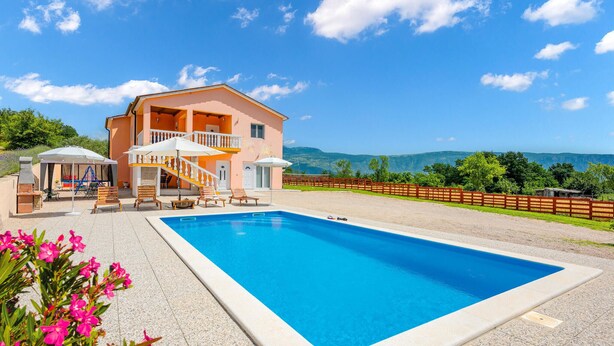 A two-story building with a pool, outdoor seating, and a view of mountains. - Lovely home in Podpican (Podpican)