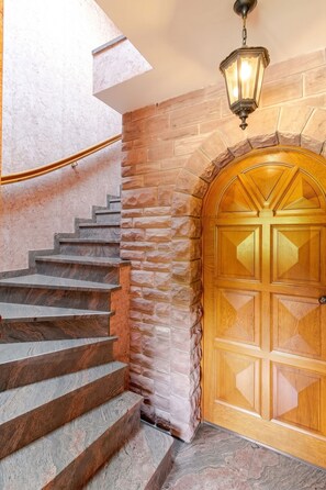 A staircase with stone steps leading to a wooden door with glass panels. - Homerez - Apartment in Epfig (Epfig)