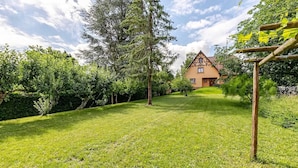 A house with a sloped roof and a well-maintained lawn in front.