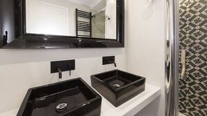 A bathroom with two black sinks, a large mirror, and a shower with a geometric tile pattern. - Balthazar, 4BR/4BA, 9 people (París)