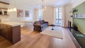 A modern apartment with a kitchen, dining area, living room, and a balcony.