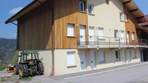 A large two-story building with a wooden facade and multiple windows.