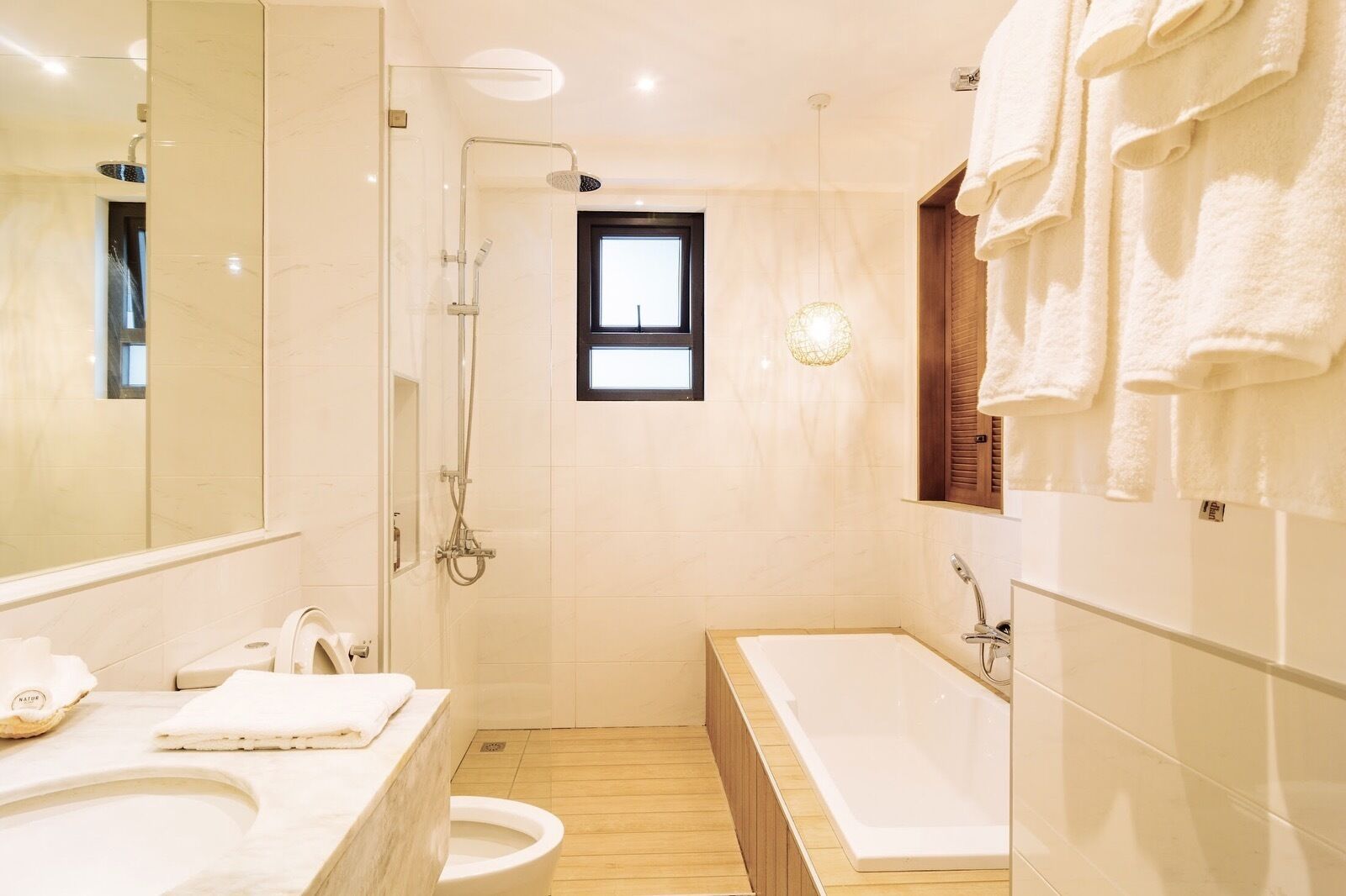 A modern bathroom with a bathtub, a shower, a toilet, and a sink.