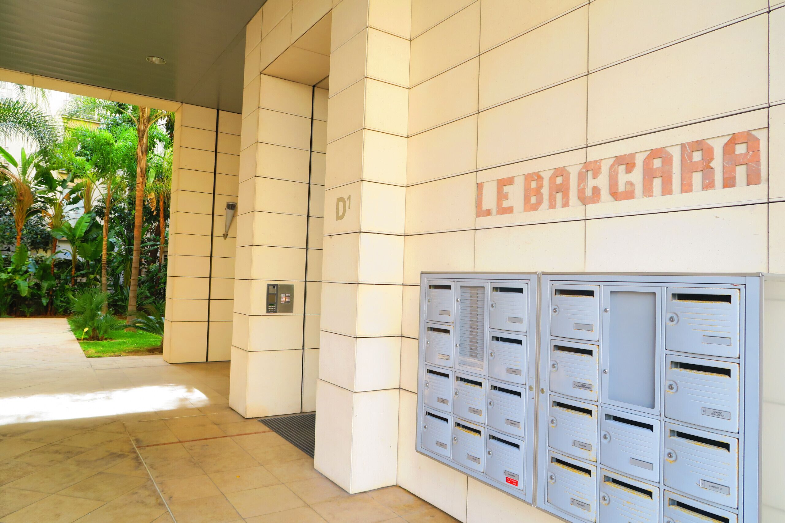 A building entrance with a sign reading "LEBACCARA" and a row of mailboxes.