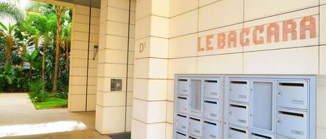 A building entrance with a sign reading "LEBACCARA" and a row of mailboxes.