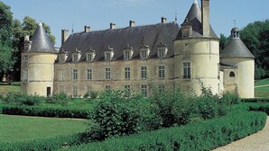 A large, historic building with multiple towers and a well-maintained garden. - Homerez - House in Éringes, parking included (Éringes)