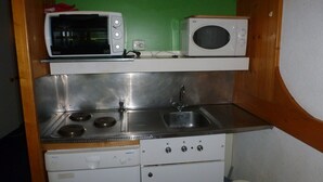 A compact kitchenette with a microwave, toaster, sink, and stove. - Ski-in studio for 5, pets allowed at Arc 1800 (Les Arcs 1800)