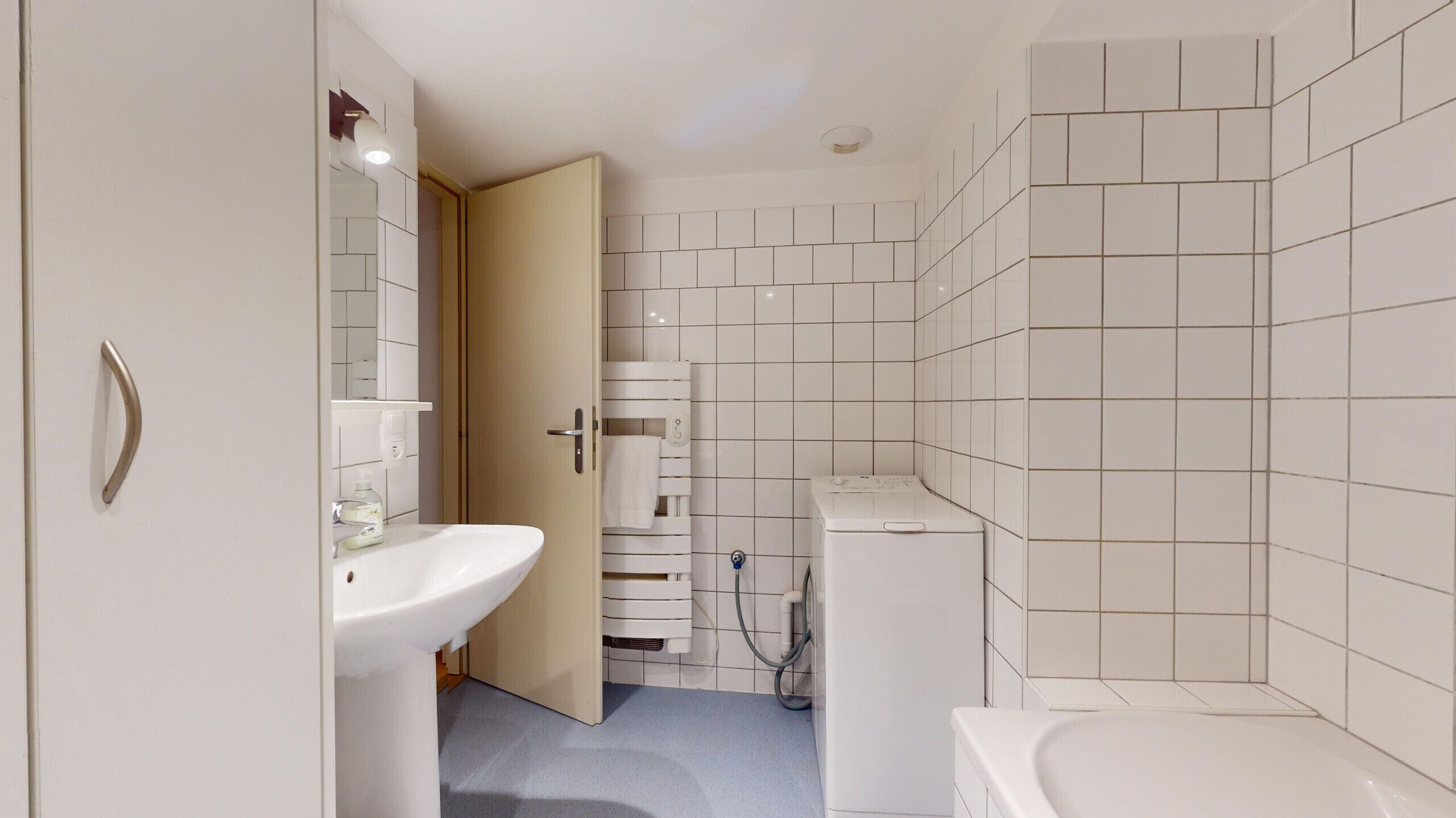 A modern bathroom with a sink, toilet, and bathtub.