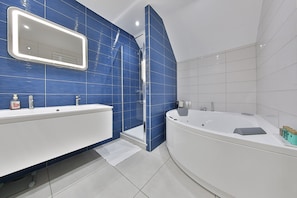 Bathtub, hair dryer, bathrobes, slippers