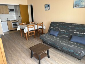A compact living space with a kitchenette, a dining area, and a sofa with a 'comfort zone' theme. - 2-room apartment with balcony and parking in Saint-Gilles-Croix-de-Vie (Saint-Gilles-Croix-de-Vie)