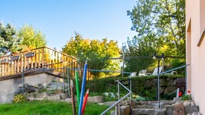 A stone staircase with metal railings leading to a wooden deck. - Homerez - Spacious House in Gérardmer (Gérardmer)