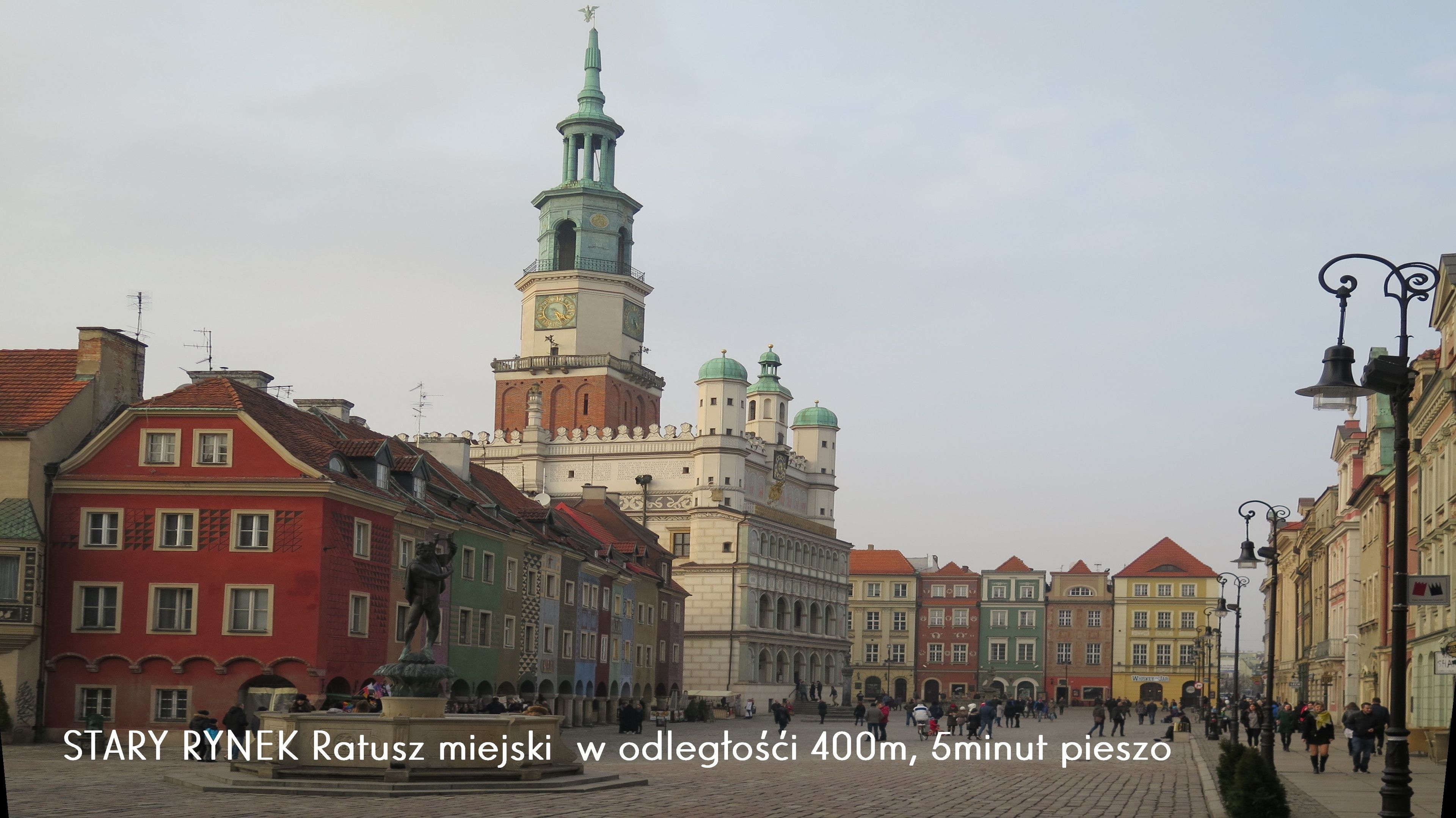 A historic square with a prominent tower and colorful buildings.