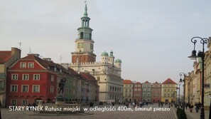 A historic square with a prominent tower and colorful buildings.